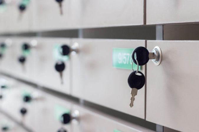 Une clé insérée dans la serrure d'une rangée de boîtes aux lettres métalliques pour assurer la sécurité boîte aux lettres.
